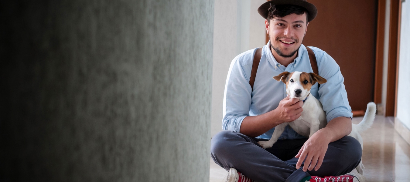 hipster young man posing with jack russell dog